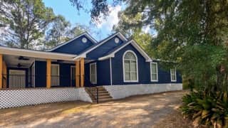 Navy blue wood siding exterior repaint in Loxley, Alabama