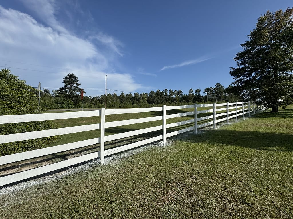 White Painted Three-Rail Wood Fence: Exterior Painting in Stapleton, Baldwin County, Alabama by Paint Doctors LLC.