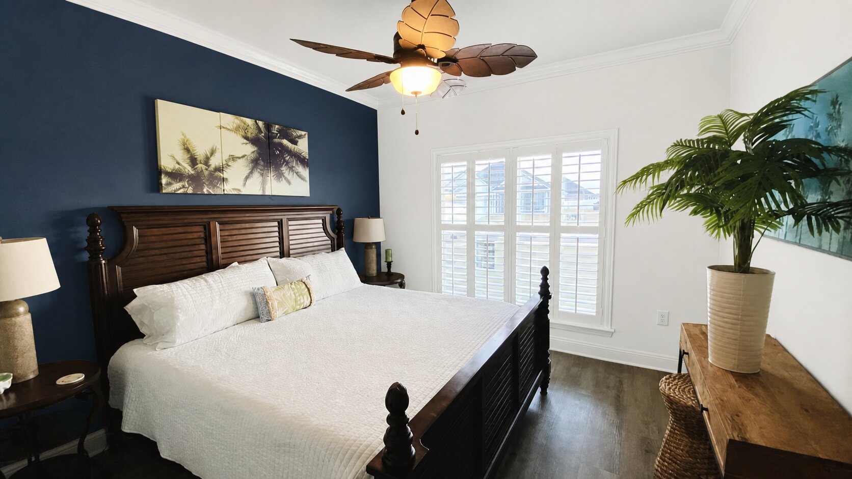 Paint Guru render — a deep navy accent wall behind the bed, the other walls and trim in bright white