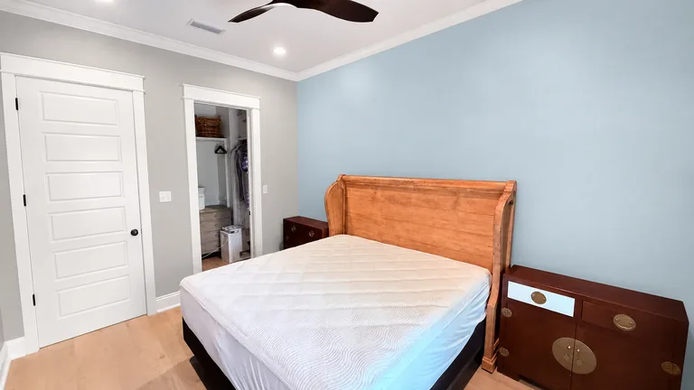 Paint Guru render — bedroom repainted Sky High over Repose Gray with Pure White trim after wall work