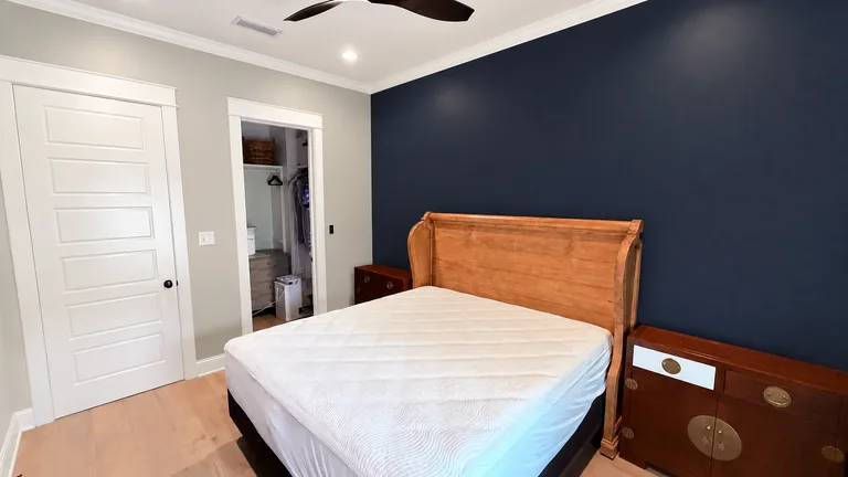Paint Guru render — bedroom with a Naval accent wall behind the bed, Agreeable Gray walls and Pure White trim