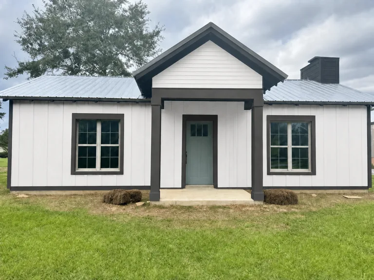 Paint Guru render — just the front door recolored to Halcyon Green on a white farmhouse