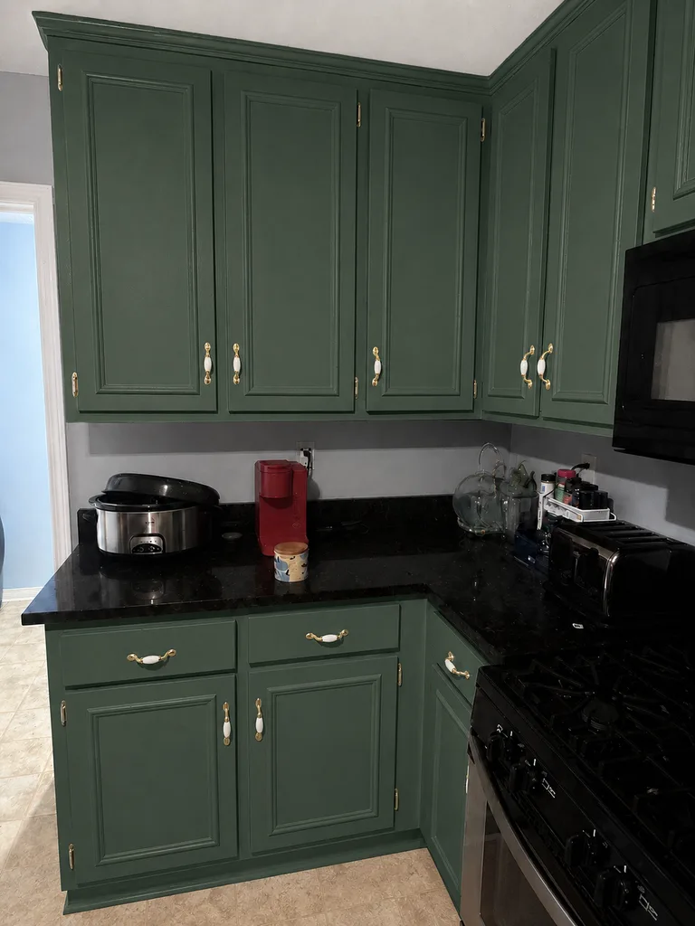 Paint Guru render — kitchen cabinets recolored to Evergreen Fog