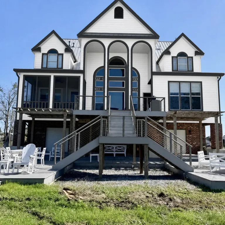 Paint Guru render — a raised coastal home taken to a crisp white body with every trim line in dark charcoal